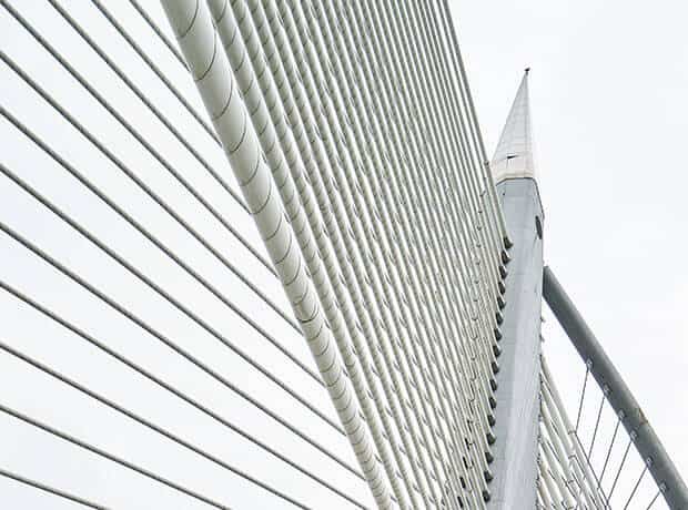 Modern high-rise building exterior with sleek white horizontal slats and advanced architectural design.