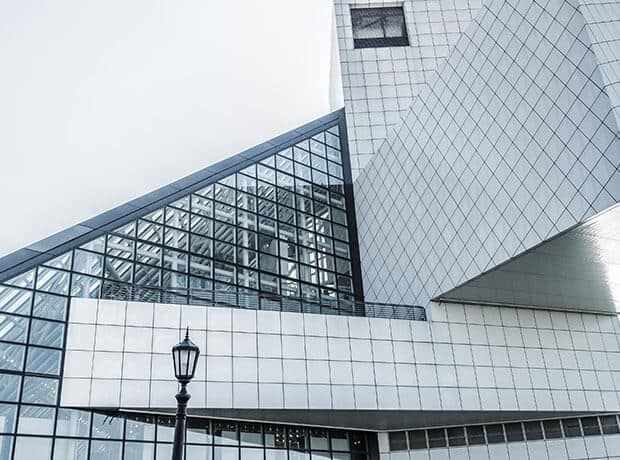 Modern glass and steel office building with geometric architecture.