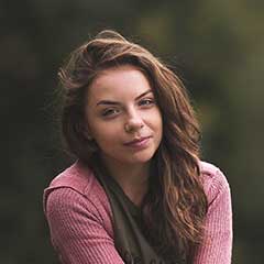 Elegant young woman outdoors, showcasing natural beauty and confidence.