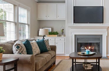 A living room with a fireplace and tv.